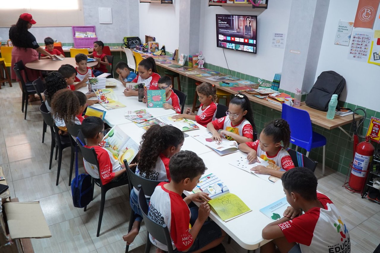 Crianças participam de atividade de leitura em uma biblioteca comunitária no Brasil.